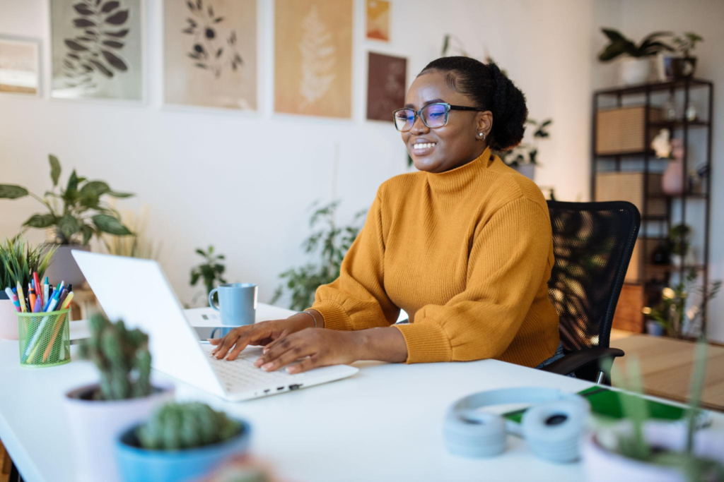 African entrepreneur working in office on laptop and using e-learning platforms for education