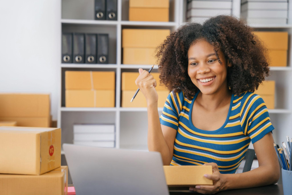 Happy businesswoman smiling at sales success after checking profits from home online store, concept of online commerce and e-commerce.